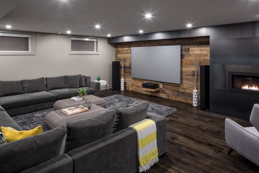 A cozy finished basement with barnwood walls by Just Basements Ottawa